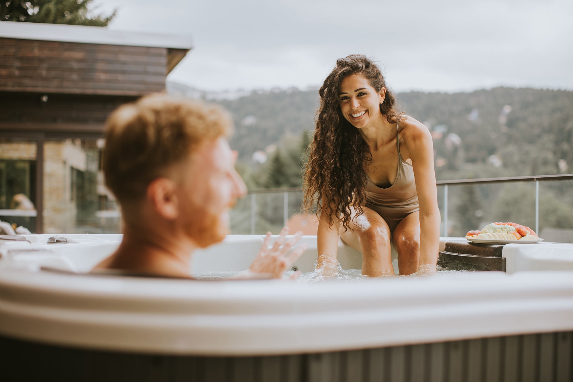 couple enjoying outdoor hottub